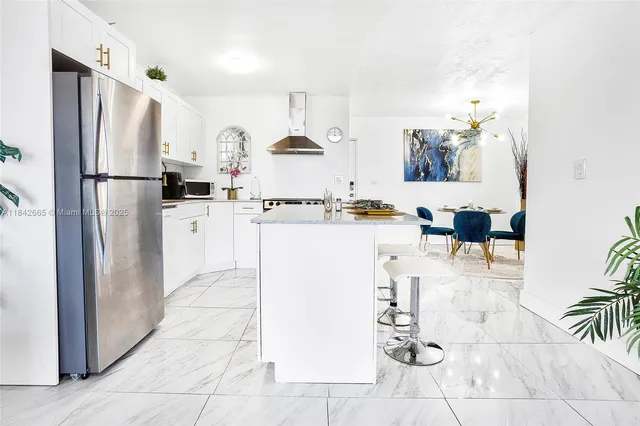 a white kitchen with cabinets and stainless steel appliances