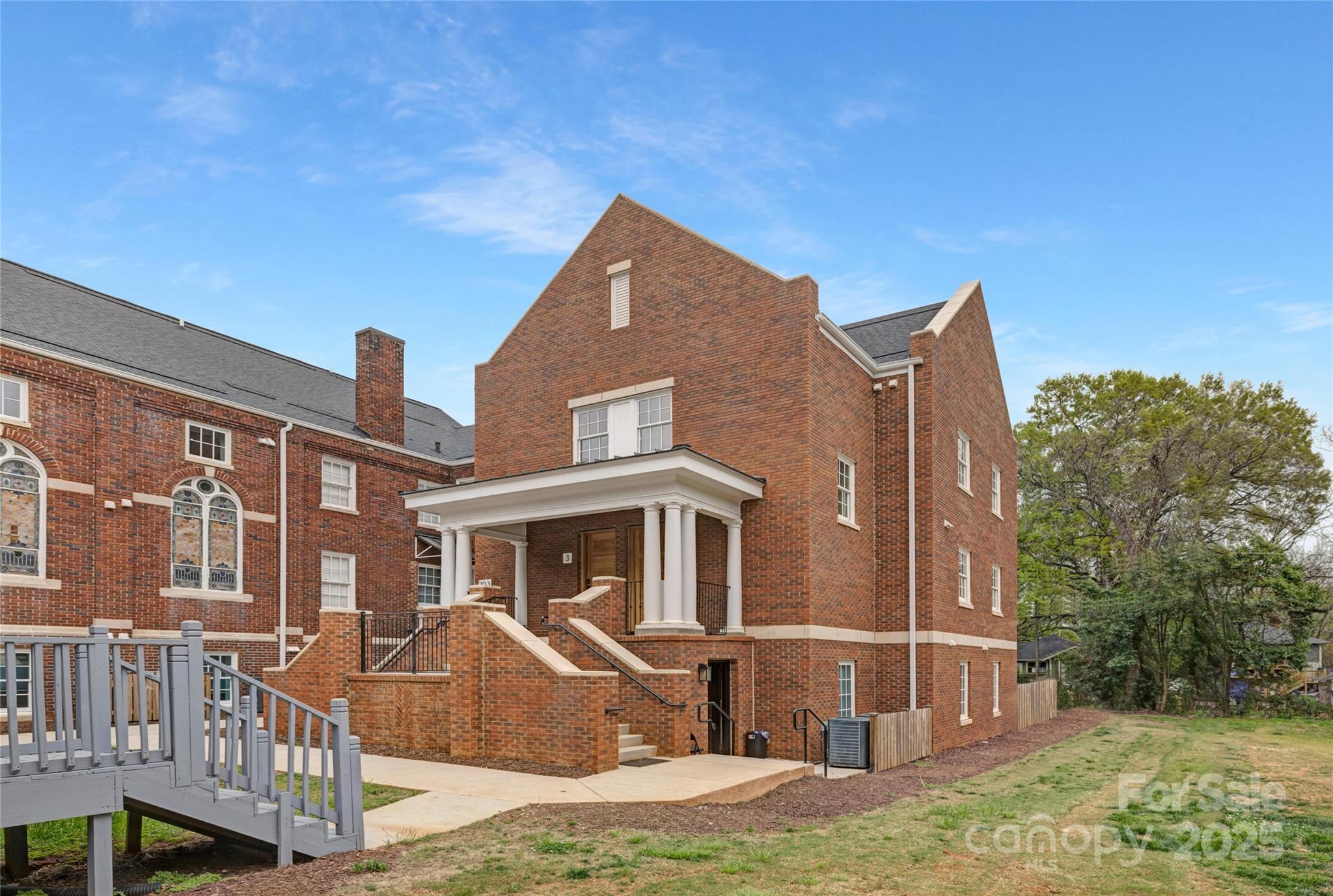 203 Grandin Road, Unit 2 Charlotte, NC 28208 - Photo 1 of 23 a front view of a house with a yard
