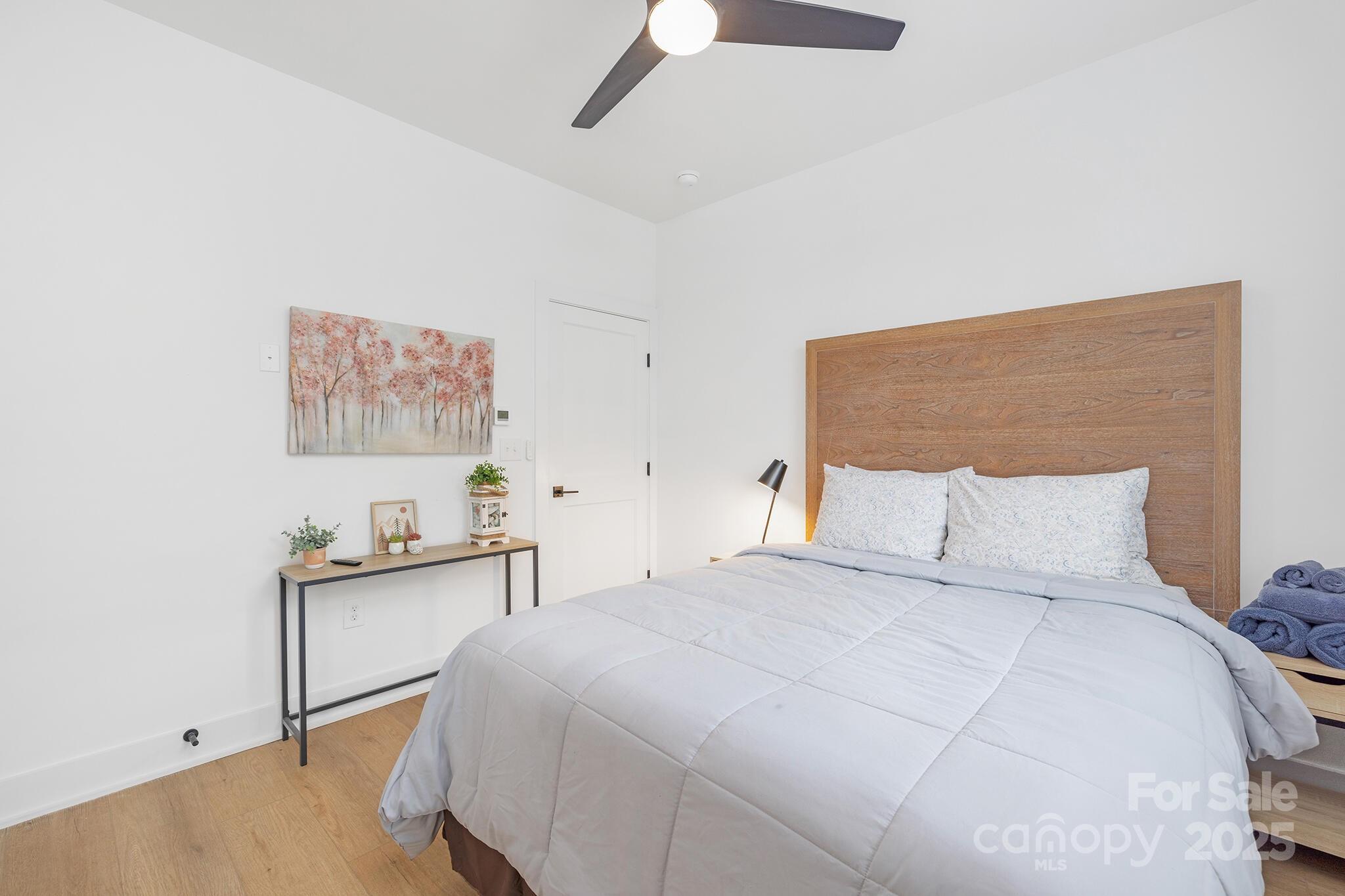 203 Grandin Road, Unit 2 Charlotte, NC 28208 - Photo 13 of 23 a bedroom with a bed and a lamp on dresser