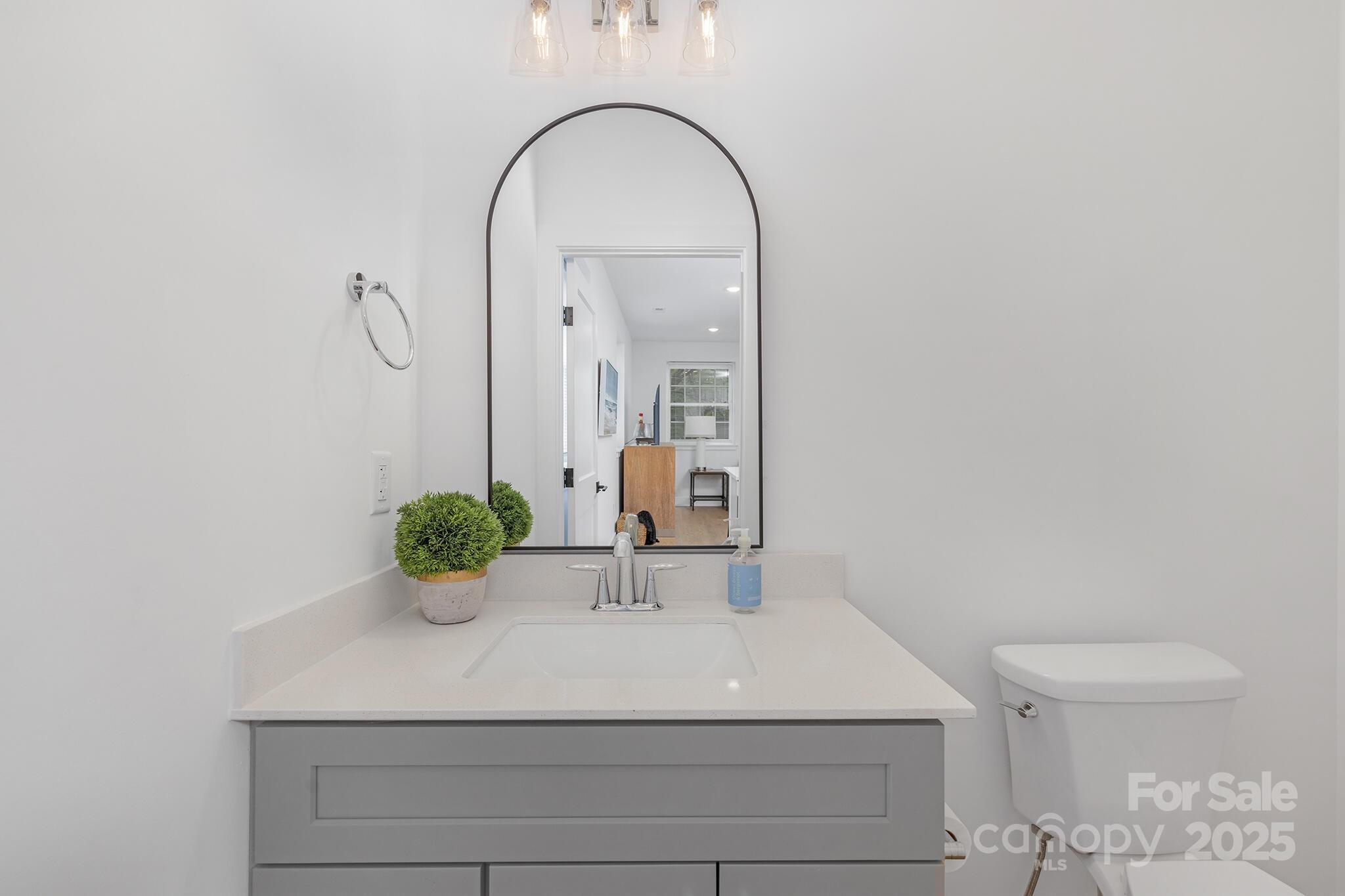 203 Grandin Road, Unit 2 Charlotte, NC 28208 - Photo 18 of 23 a bathroom with a sink a toilet and mirror