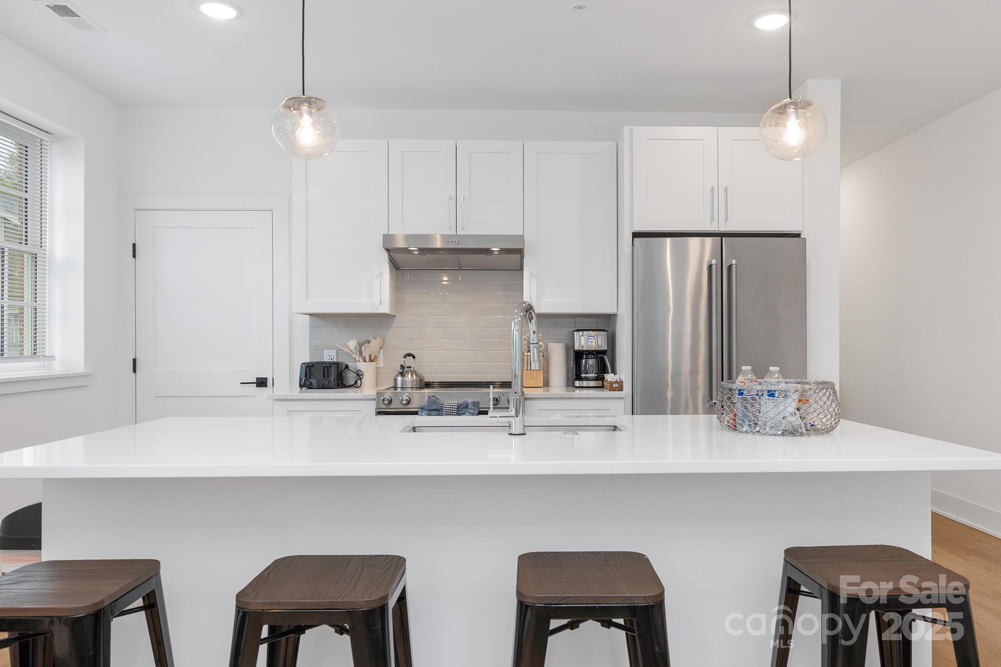 203 Grandin Road, Unit 2 Charlotte, NC 28208 - Photo 7 of 23 a kitchen with stainless steel appliances a sink and cabinets