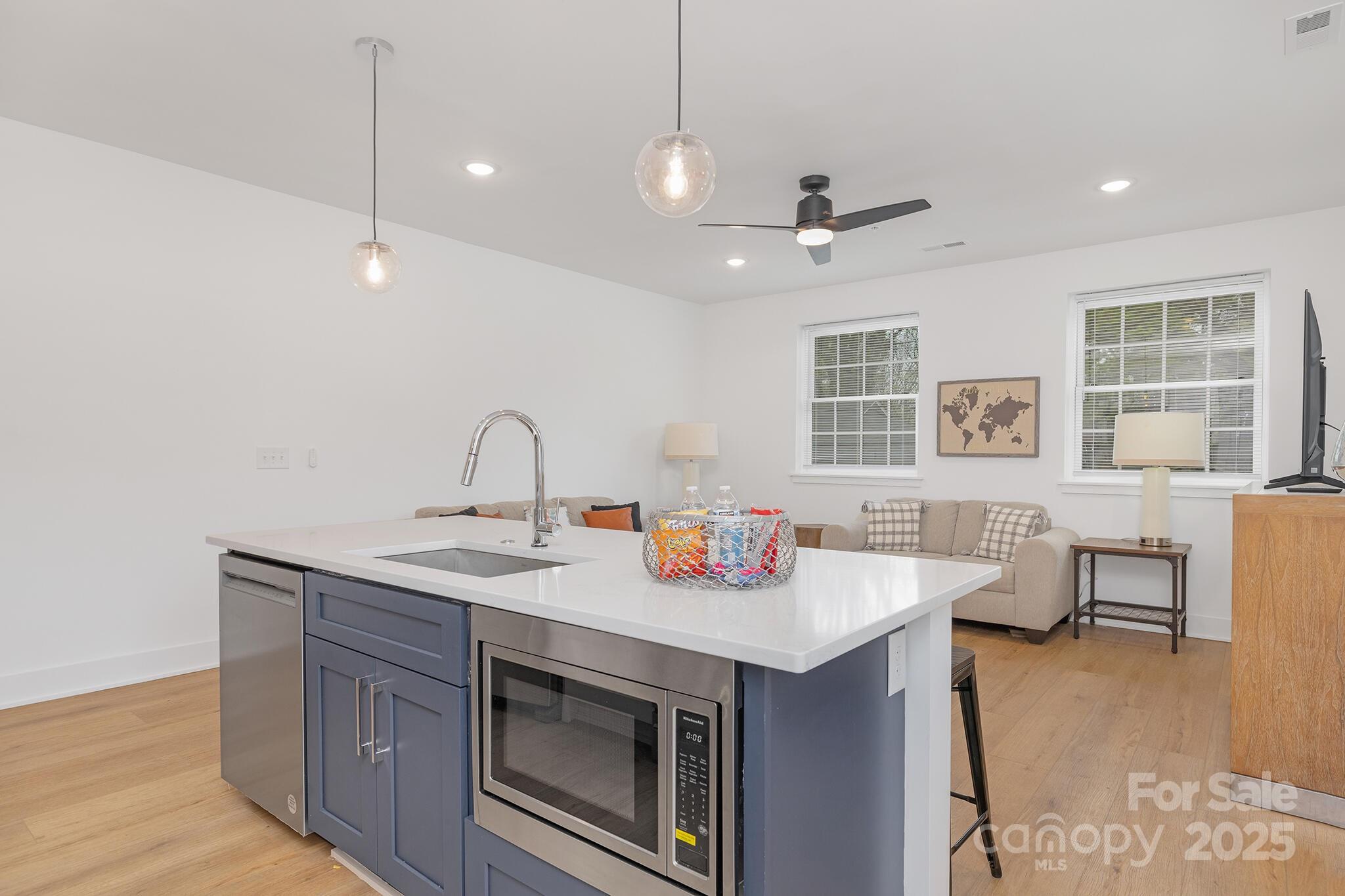 203 Grandin Road, Unit 2 Charlotte, NC 28208 - Photo 10 of 23 a open kitchen with stainless steel appliances granite countertop a sink stove and wooden floor