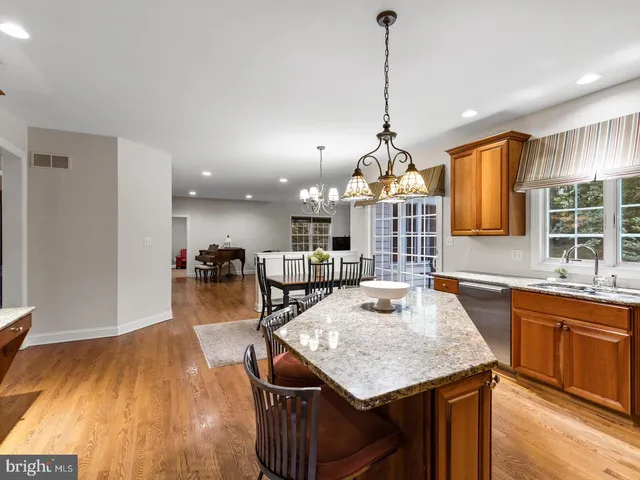 a kitchen with sink table and chairs