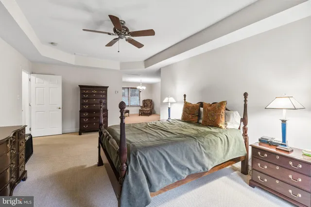 a bed room with a bed and a ceiling fan