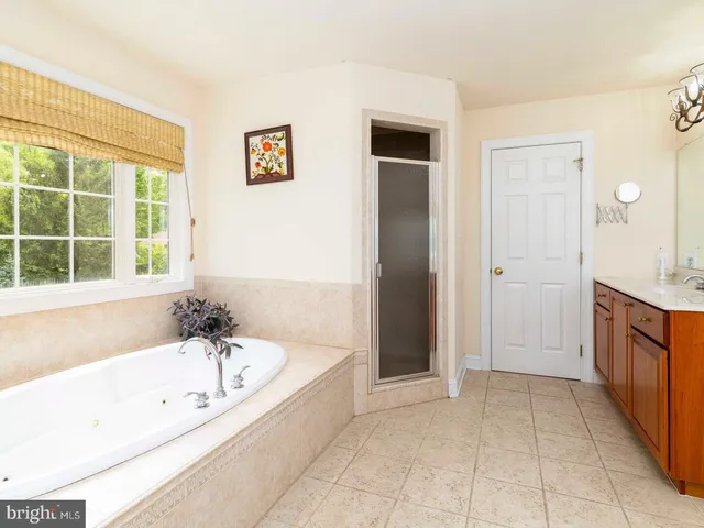 a spacious bathroom with a bathtub and a shower