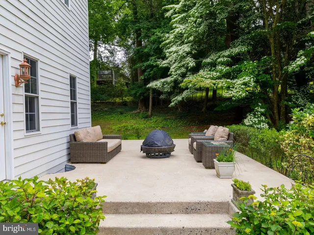a view of a patio with table and chairs and potted plants