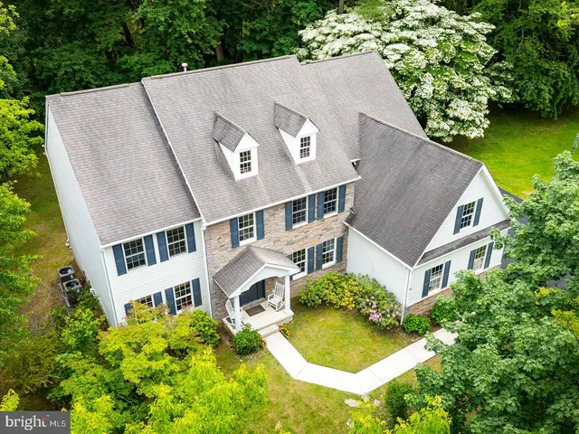 an aerial view of a house with swimming pool and garden