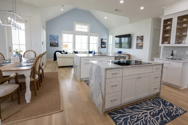 a kitchen with sink refrigerator dining table and chairs