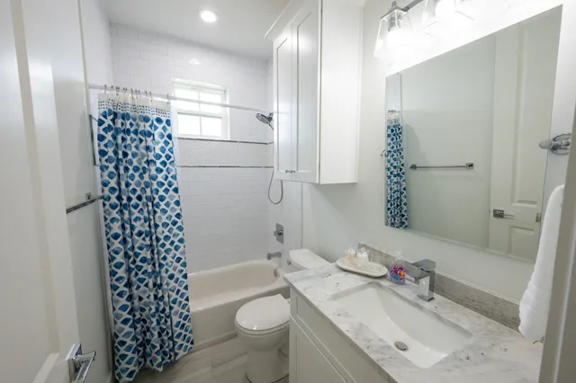 a bathroom with a sink toilet and shower