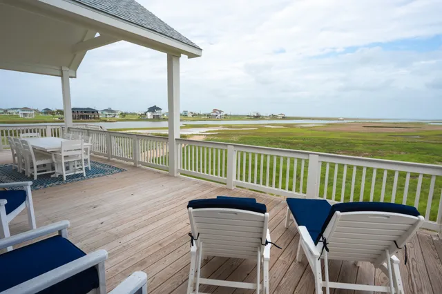 an aerial view of a house with a garden and lake view