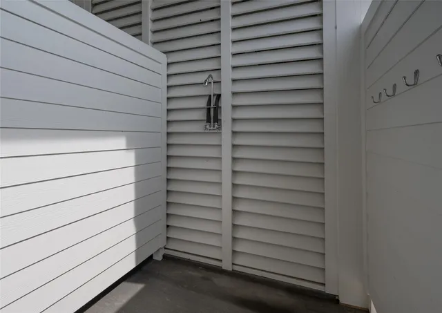 a view of a yard with a table and chairs under an umbrella