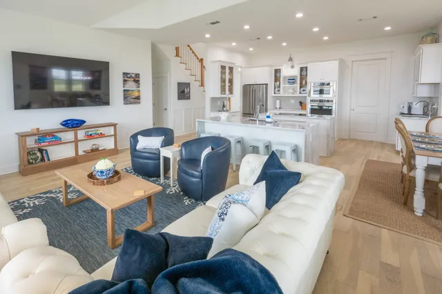 a view of a dining room with furniture and chandelier