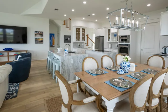 a view of a dining room with furniture a chandelier and wooden floor