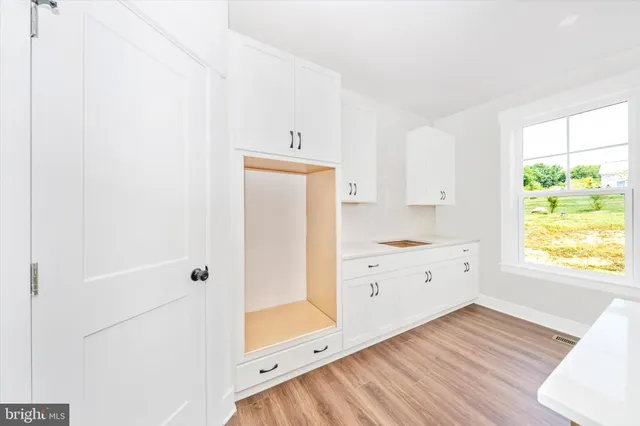 a room with a window and a dresser