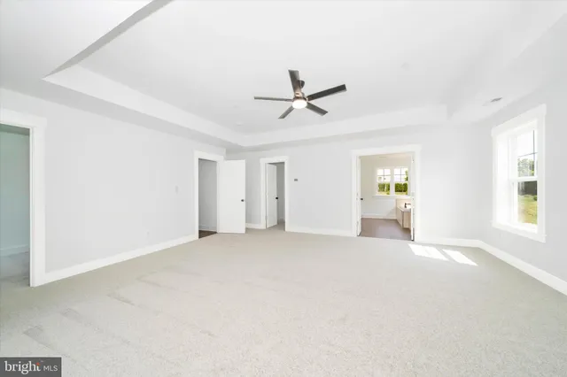 a view of a livingroom with a window and a kitchen