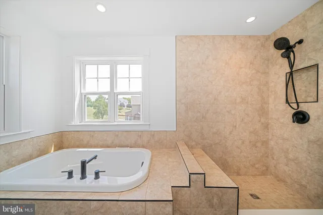 a bathroom with a tub and a window