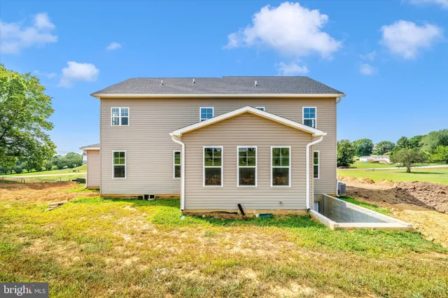 a view of a house with a backyard