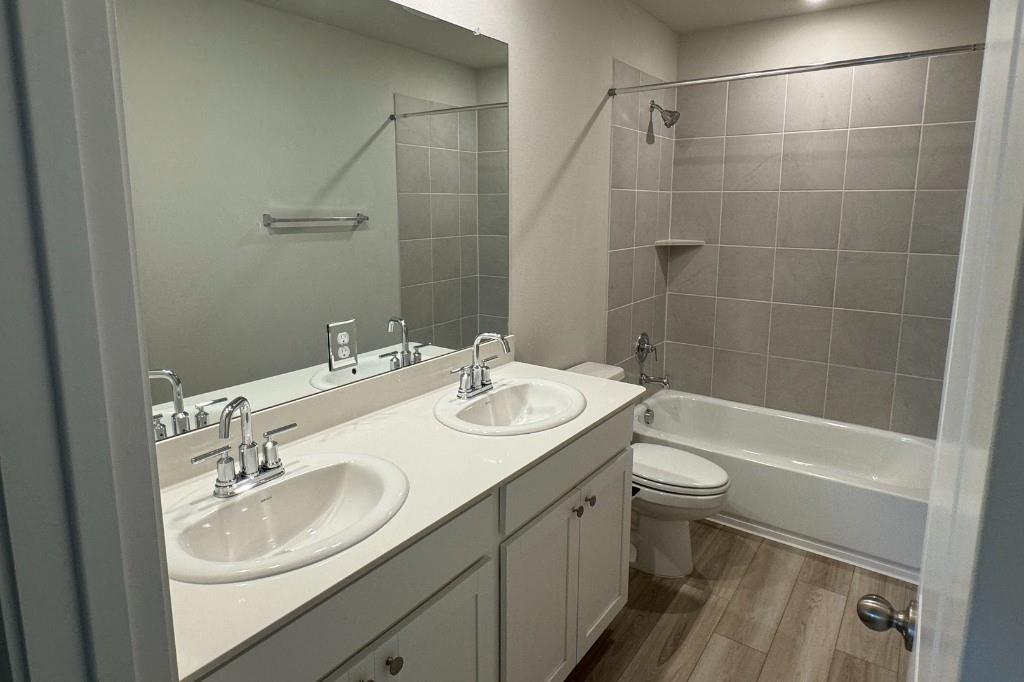 12604 Dairywork Road Buda, TX 78610 - Photo 14 of 20 Dual vanity sinks provide ample space in this practical and polished bathroom.