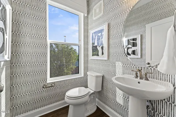 a bathroom with a sink a mirror and a toilet