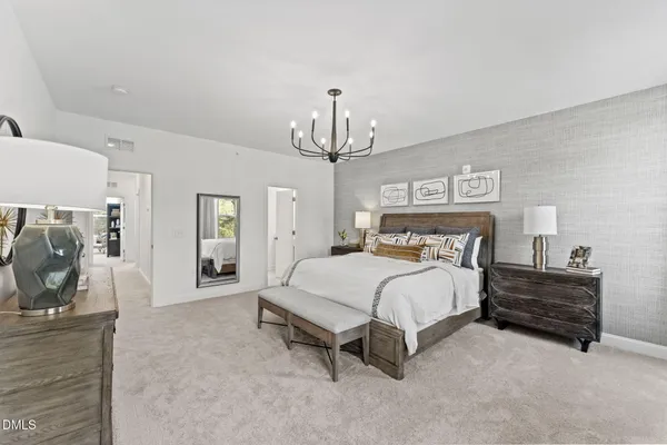 a bed room with a bed and a chandelier