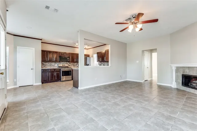 a view of a kitchen with a stove cabinets wooden floor and a ceiling fan