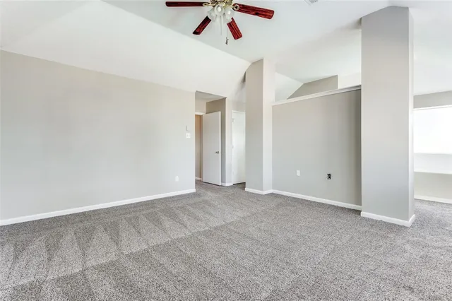 a view of an empty room with a ceiling fan