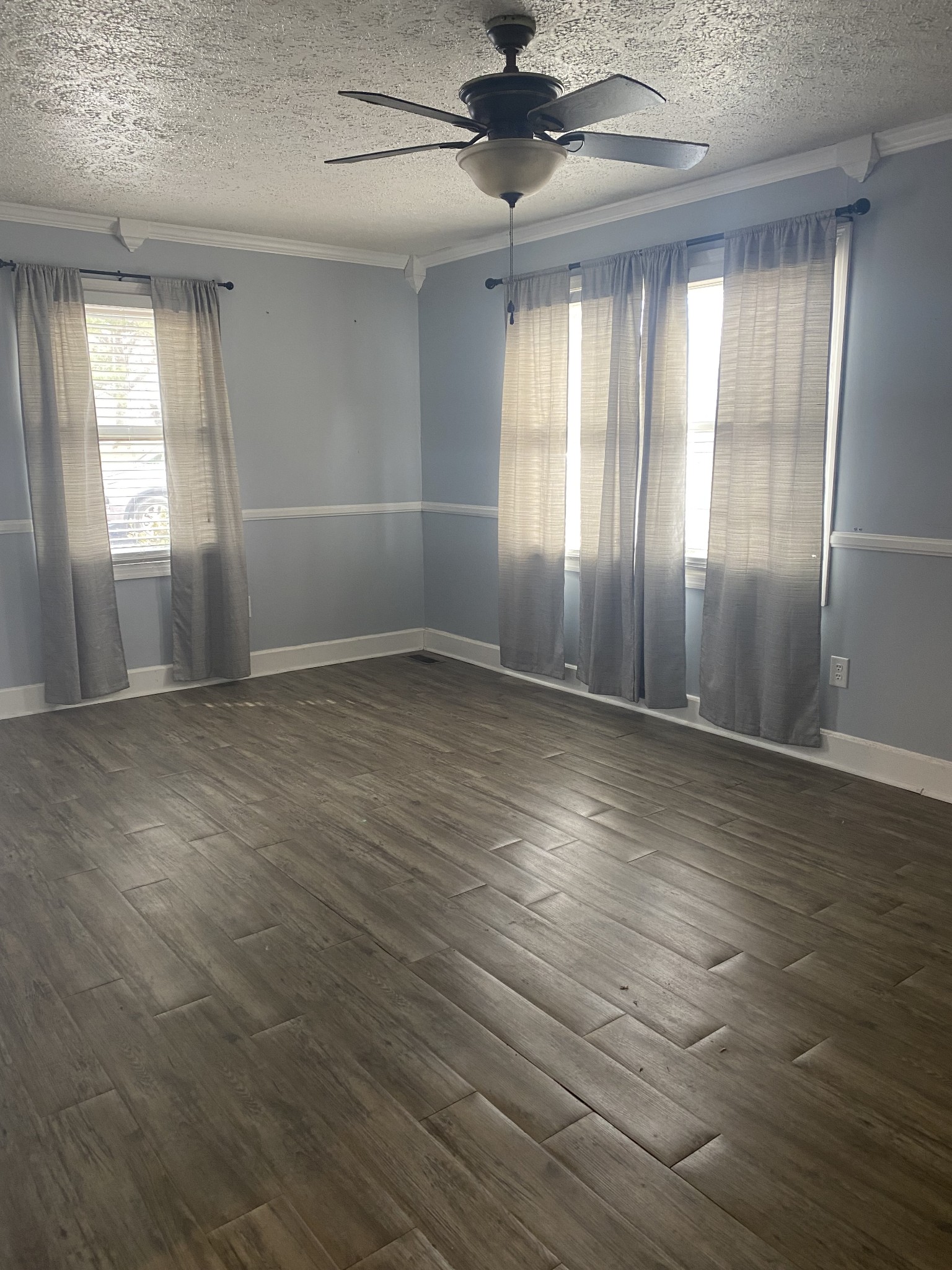 825 Moore Hollow Road Tennessee Ridge, TN 37178 - Photo 3 of 12 an empty room with wooden floor and windows