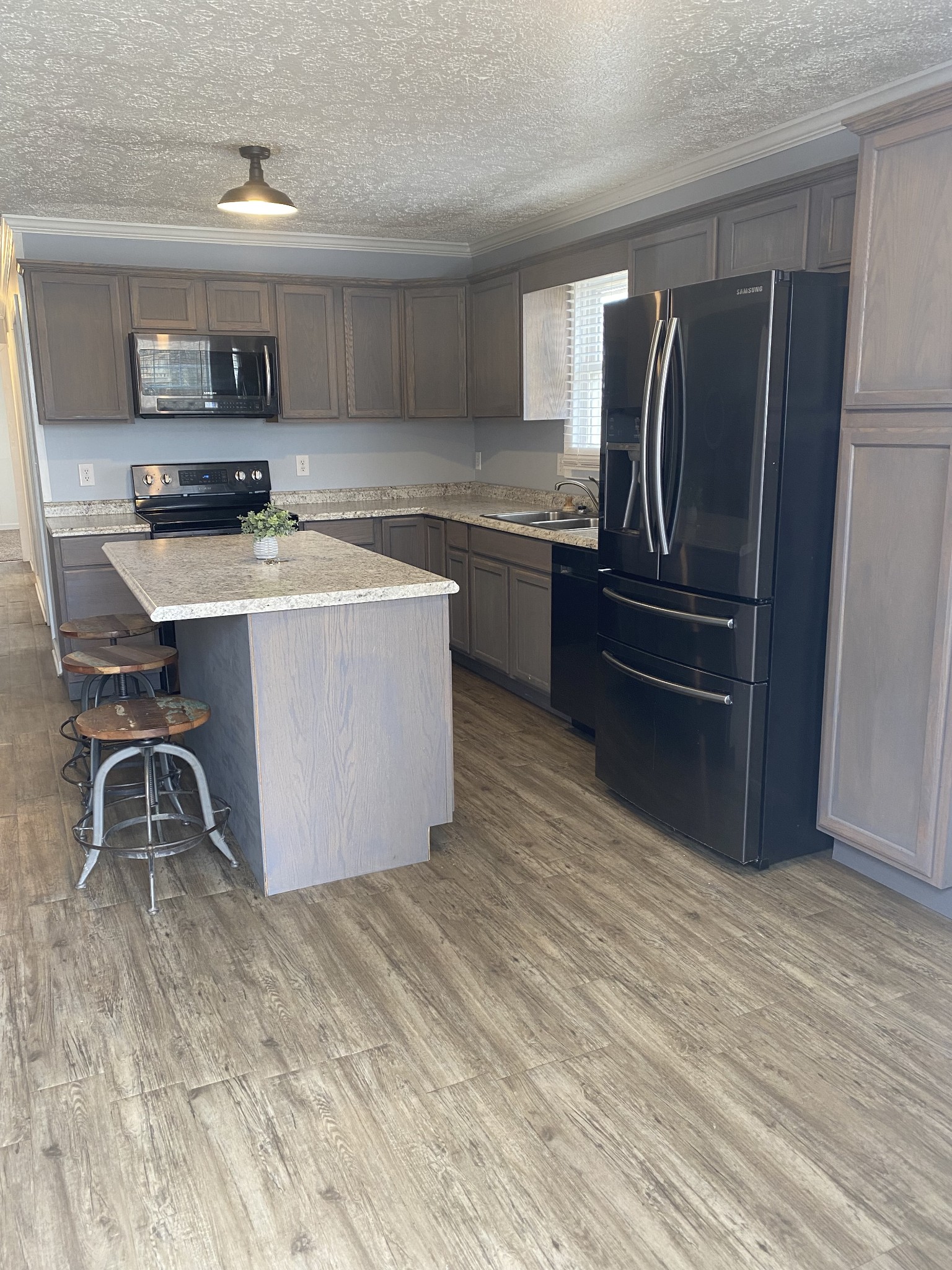 825 Moore Hollow Road Tennessee Ridge, TN 37178 - Photo 5 of 12 a kitchen with stainless steel appliances a sink a stove a refrigerator and cabinets