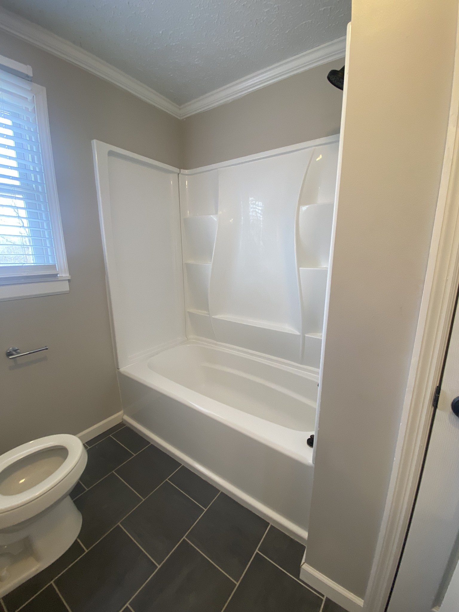 825 Moore Hollow Road Tennessee Ridge, TN 37178 - Photo 9 of 12 a bathroom with a toilet and a shower