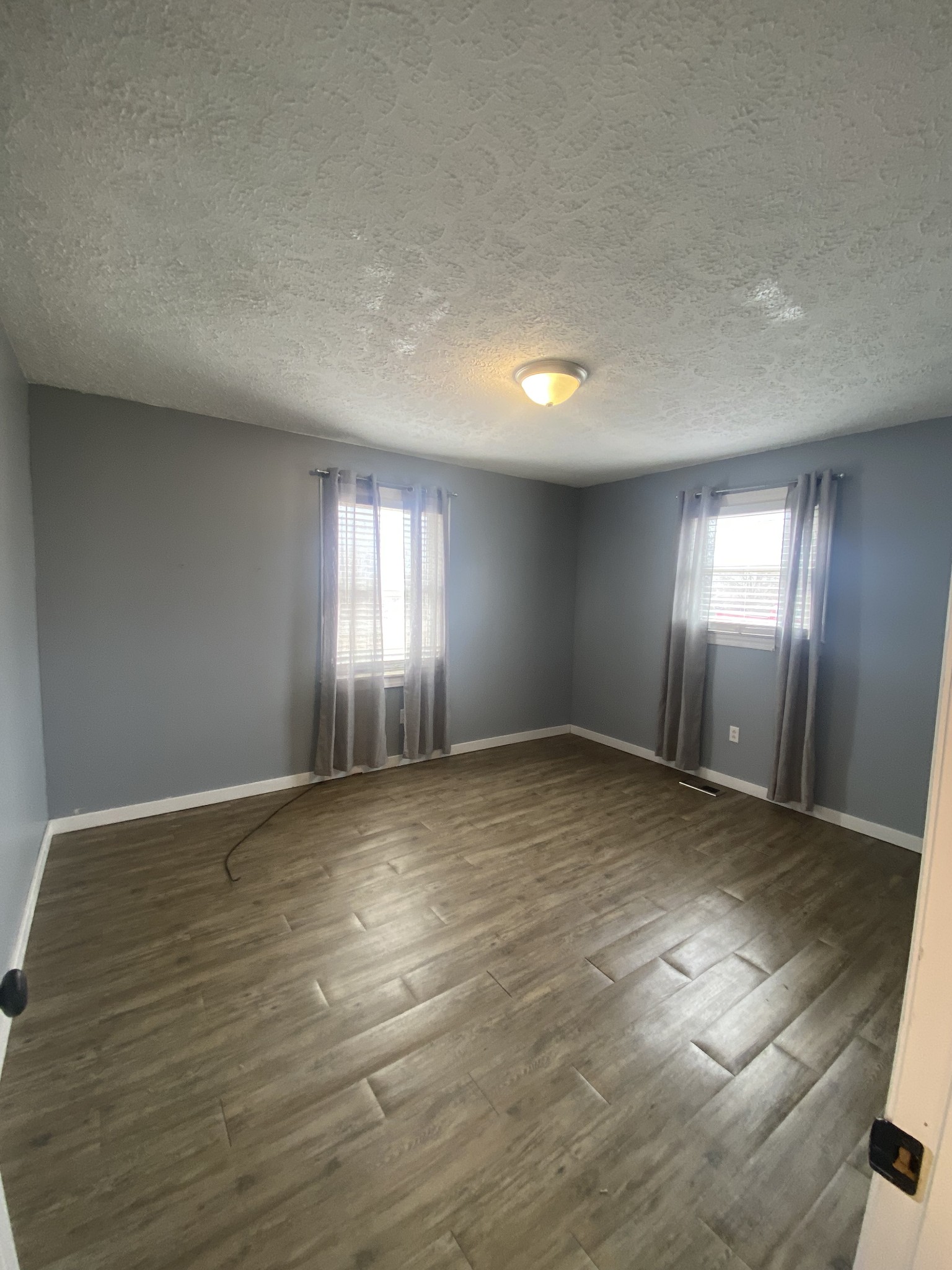 825 Moore Hollow Road Tennessee Ridge, TN 37178 - Photo 10 of 12 an empty room with window and wooden floor