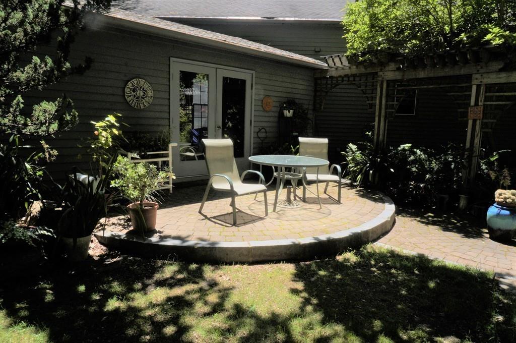 522 Leadmine Road Sturbridge, MA 01566 - Photo 23 of 33 a view of a patio with table and chairs potted plants and large tree