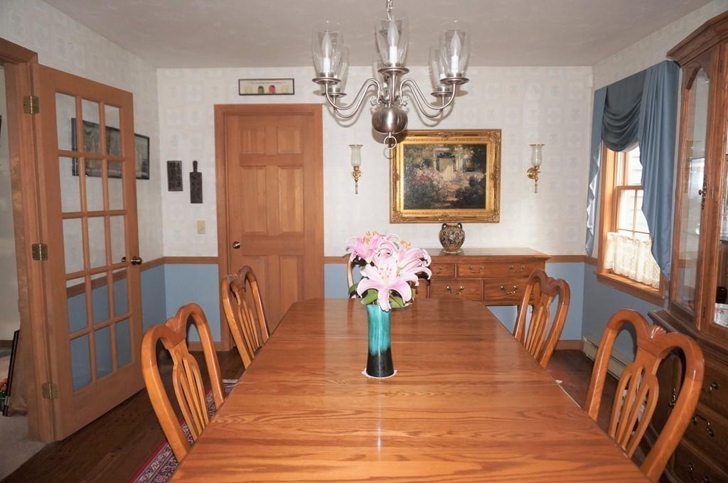 522 Leadmine Road Sturbridge, MA 01566 - Photo 7 of 33 a view of a dining room with furniture a chandelier and wooden floor