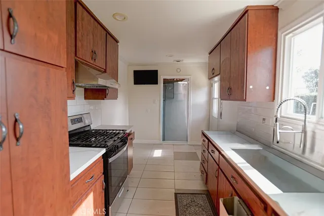 a kitchen with granite countertop a stove and a sink