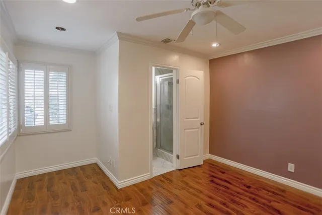 an empty room with a window and wooden floor