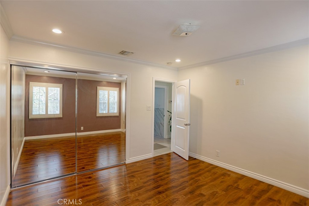 1402 North Parsons Place Santa Ana, CA 92703 - Photo 5 of 16 a view of an empty room with wooden floor and a window
