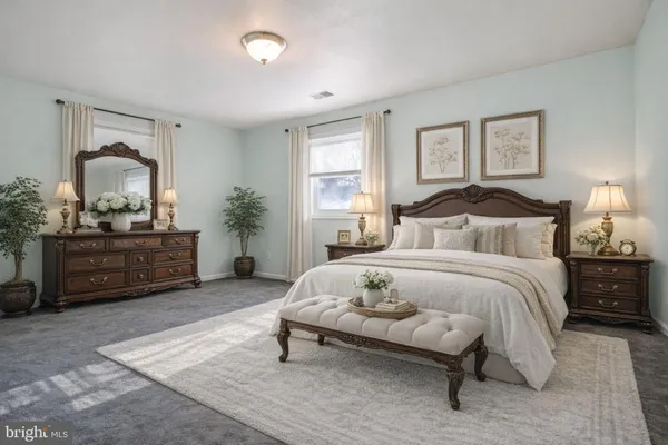 a bedroom with a bed a lamp and a couch