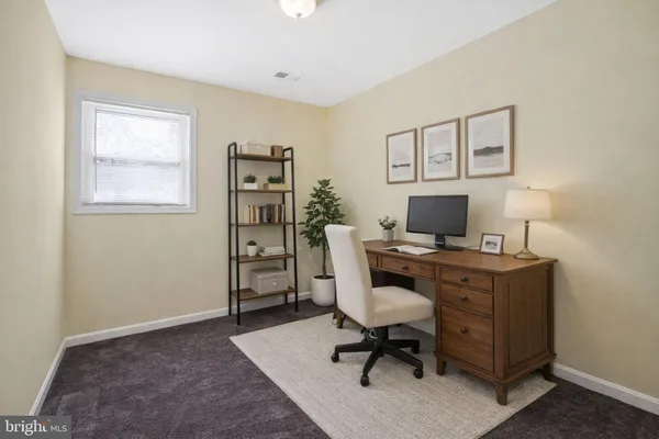 a view of a workspace with furniture