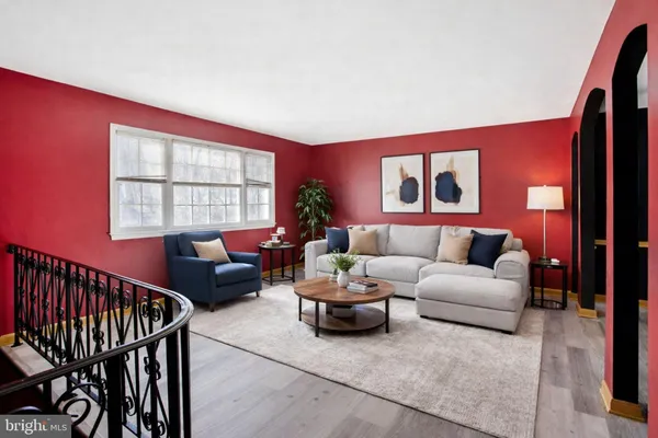 a living room with furniture a window and a flat screen tv