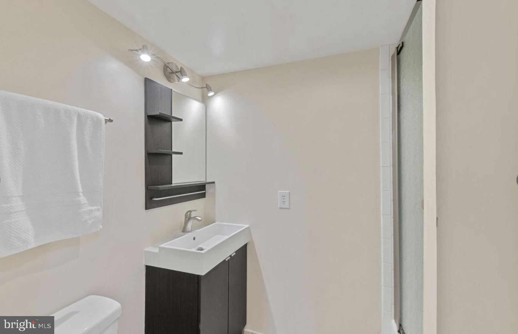 1401 North Rhodes Street, Unit 406 Arlington, VA 22209 - Photo 11 of 14 Sleek modern bathroom with elegance.