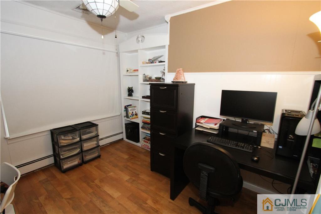 30 Brookville Road Edison, NJ 08817 - Photo 13 of 25 a bedroom with a bed and a flat screen tv
