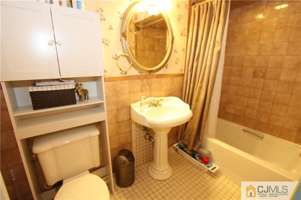 30 Brookville Road Edison, NJ 08817 - Photo 14 of 25 a bathroom with a sink and a mirror
