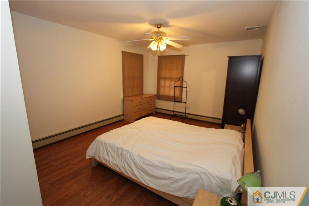 30 Brookville Road Edison, NJ 08817 - Photo 19 of 25 a bedroom with a bed and a chandelier