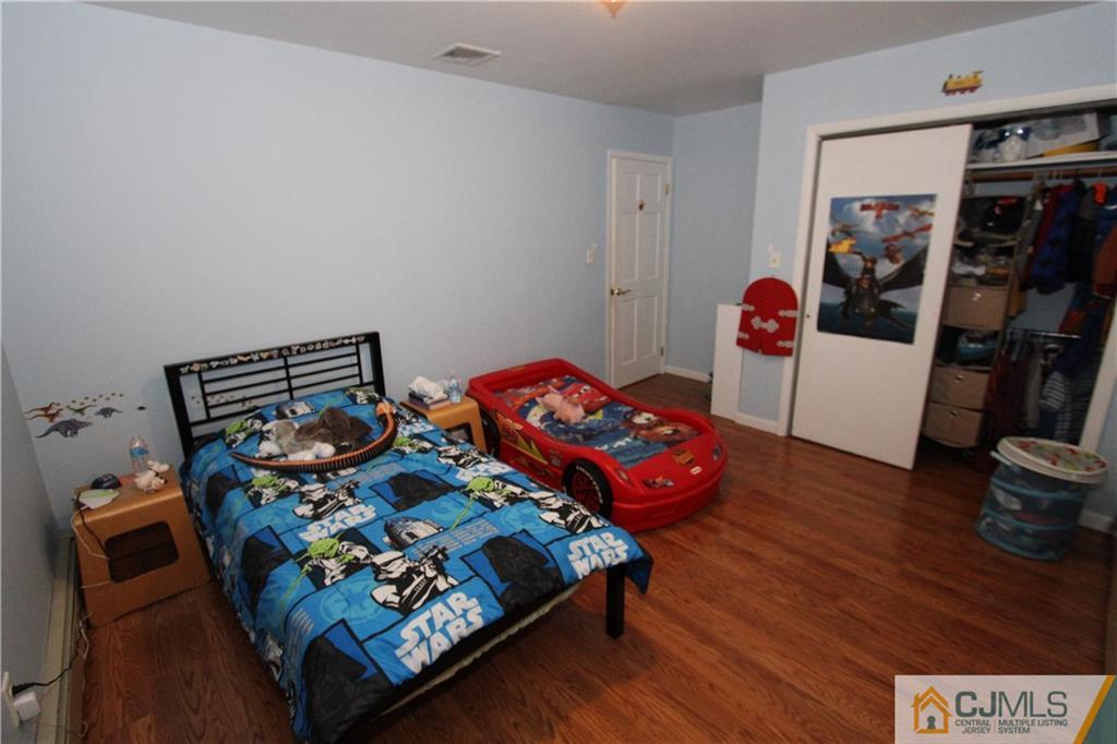 30 Brookville Road Edison, NJ 08817 - Photo 22 of 25 a bedroom with bed and a wooden floor
