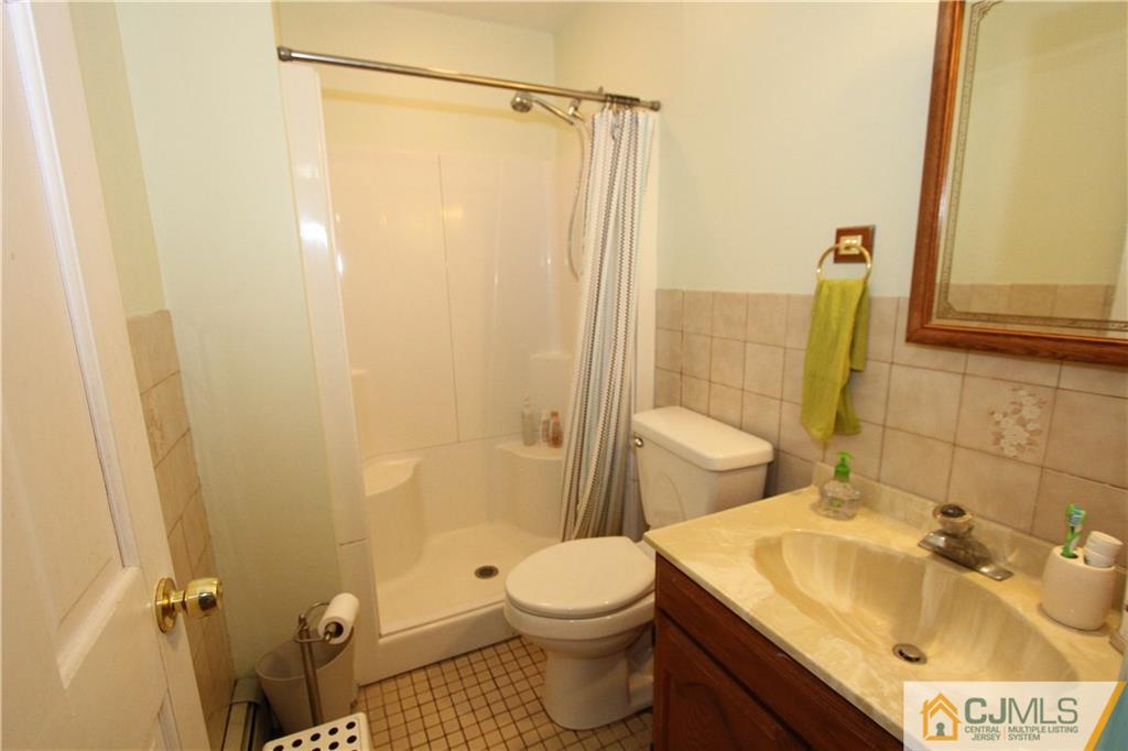 30 Brookville Road Edison, NJ 08817 - Photo 23 of 25 a bathroom with a sink a toilet and shower