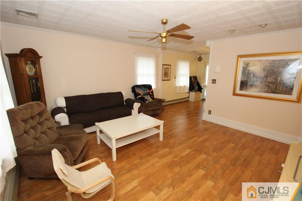 30 Brookville Road Edison, NJ 08817 - Photo 5 of 25 a living room with furniture and a wooden floor