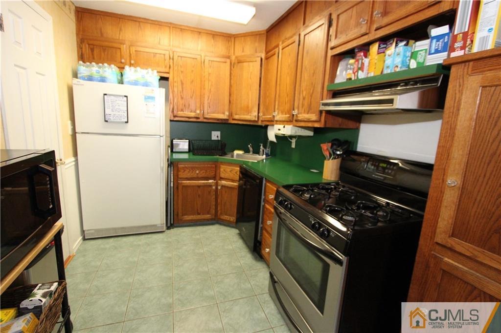 30 Brookville Road Edison, NJ 08817 - Photo 8 of 25 a kitchen with a stove and a refrigerator