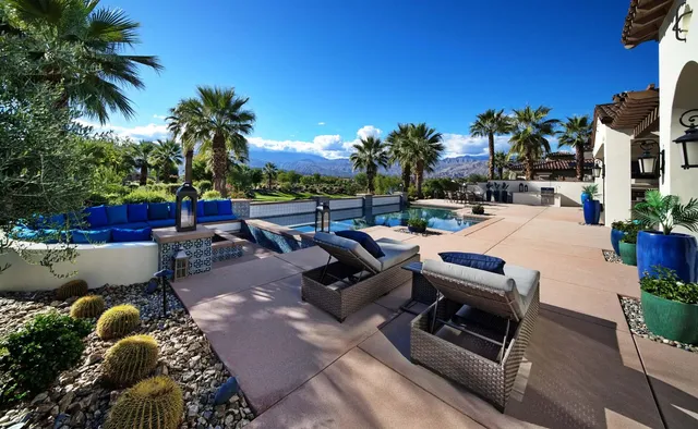 a view of a patio with couches and a table and chairs