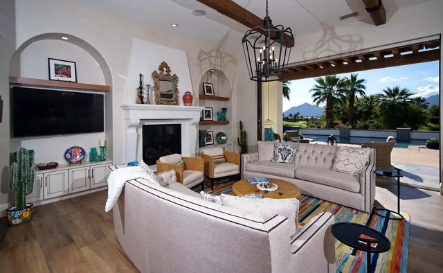 a outdoor living room with furniture and a floor to ceiling window