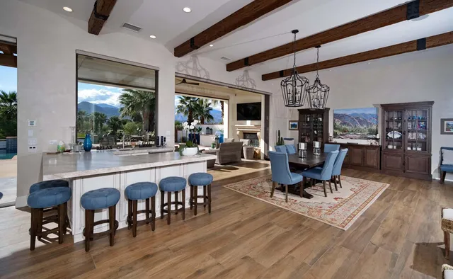 a view of a swimming pool with a lounge chair and palm trees