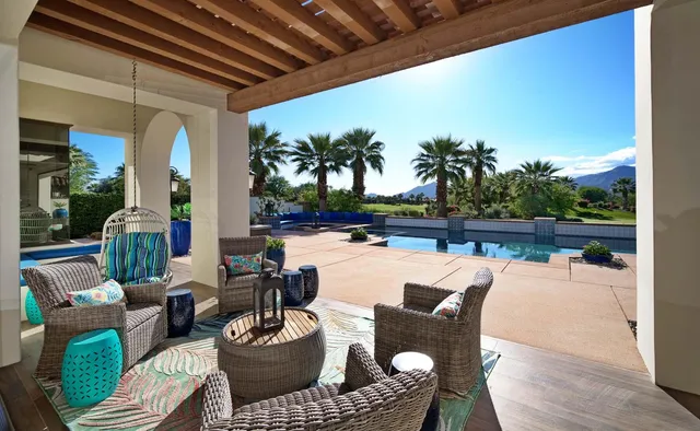 a front view of a house with garden and patio
